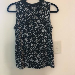 Sleeveless green patterned top.